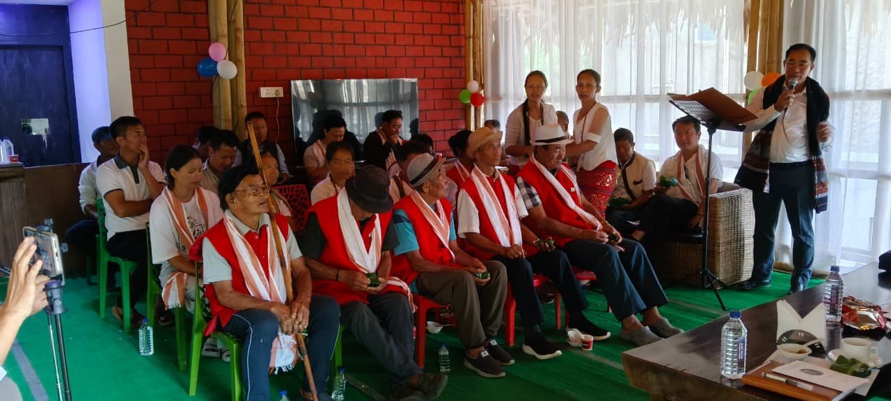 Members presenting a certificate at a community meeting